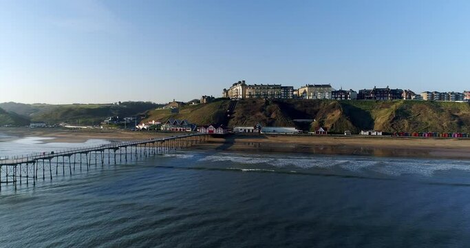 Saltburn By The Sea Drone Over Water at end of the Pier, Crossing across end of pier, pivoting around pier end in parallax - Summer, Clip 3