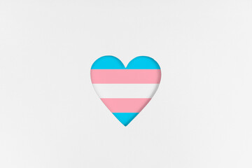 Transgender flag on Heart shape isolated on white cardboard background. Printed cardboard with...