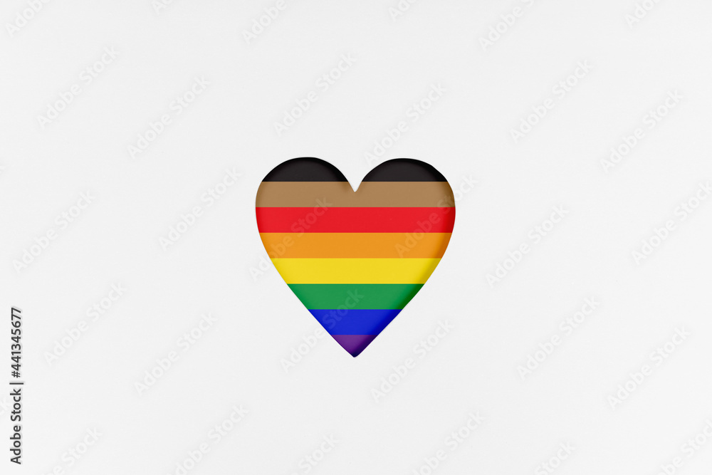 Wall mural Heart shape with New redesigned LGBTQ pride flag. Printed cardboard with die-cut heart shape. Top view