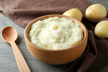 Concept of tasty eating with mashed potatoes on gray textured table