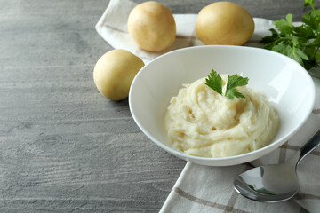 Concept of tasty eating with mashed potatoes on gray textured table