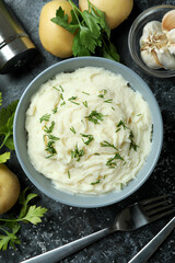 Concept of tasty eating with mashed potatoes on black smokey table