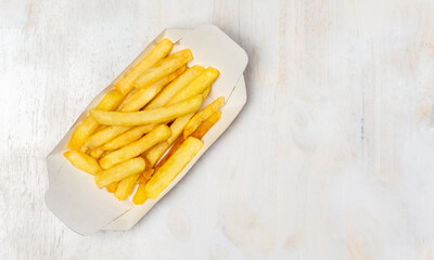 Top view French fries in a paper tray.