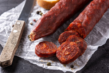 Spanish chorizo sausage on black background. Close up