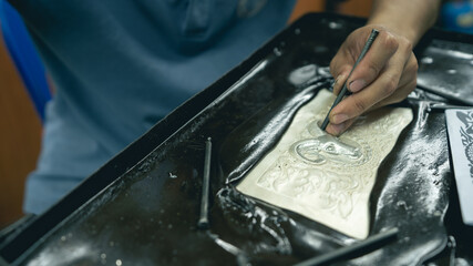 Jeweler at work in jewelry. Desktop for craft jewelry making with professional tools. Close up view of tools. Silver jewelry.