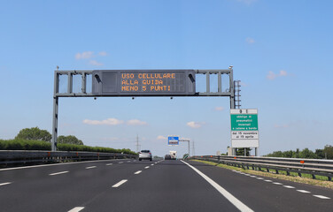 motorway sign with the inscription in Italian which means that points are deducted from the driving...
