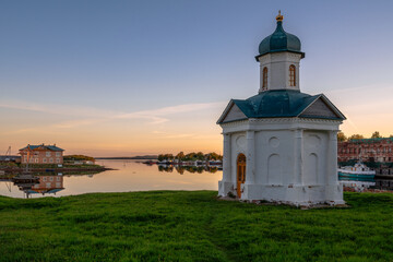 Fototapeta na wymiar View of the chapel of the Holy Prince Alexander Nevsky near the Solovetsky Monastery against the background of the dawn cloudless sky, Solovetsky Island, Arkhangelsk region, Russia
