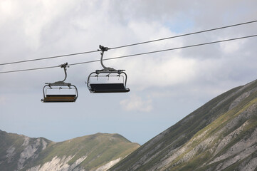 Fototapeta premium two chairlifts in the mountains to transport tourists of hikers effortlessly