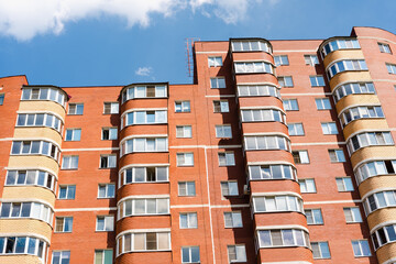 Fototapeta premium windows on colorful building, red brick multi-storey house, brick house,