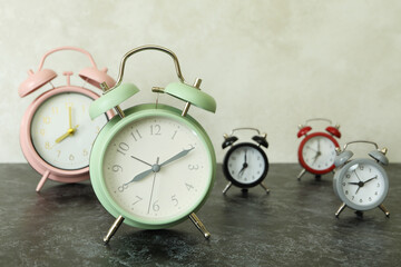 Multicolor alarm clocks on black smokey table