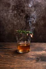 Smoked rosemary in a glass of whiskey or bourbon