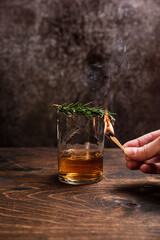 Smoked rosemary in a glass of whiskey or bourbon