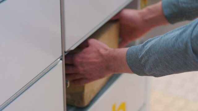 Collecting a parcel from a parcel locker in 4k slow motion 60fps
