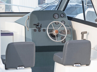 Interior of boat with steering wheel and control panel