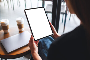 Mockup image of a woman holding digital tablet with blank white desktop screen