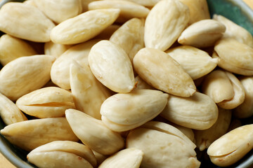 Blanched almonds in a bowl. Bowl with skinless nuts.