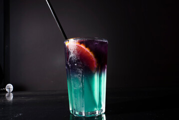 Cocktail on black background. Cocktail at the bar. Alcoholic drink at the night club.