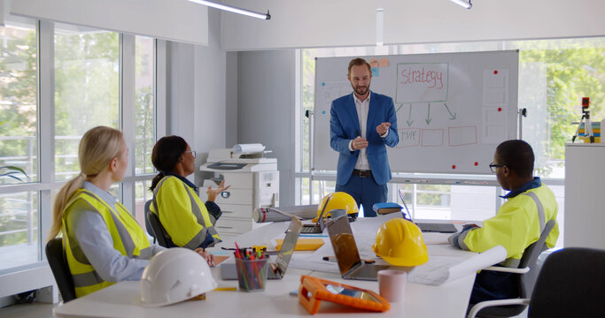 Industrial design facility team of engineers and technicians have meeting