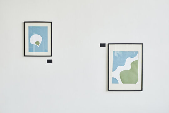 Minimal background image of two abstract paintings on white wall in modern art gallery, copy space