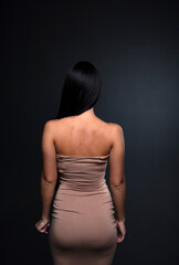 portrait of a young woman in the studio on a dark background