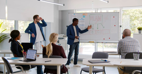 Diverse business partners presenting startup project to investors in modern office