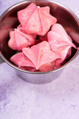 Pink meringue on a purple marble background