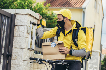 Male courier with bicycle delivering packages