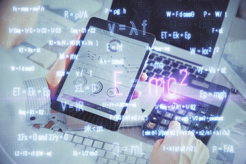 Double exposure of man's hands holding and using a phone and formulas drawing. Education concept.