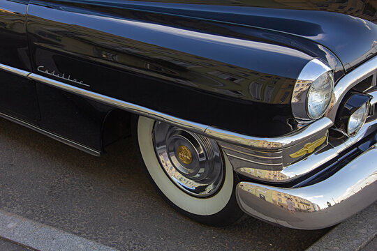 ST. PETERSBURG, RUSSIA - JUNE 9, 2021:  Cadillac Coupe Deville 1950s, Black Executive Car, Old Classic Retro Auto, Era Of Great Gatsby, City Reflections On A Shiny Car Bodywork