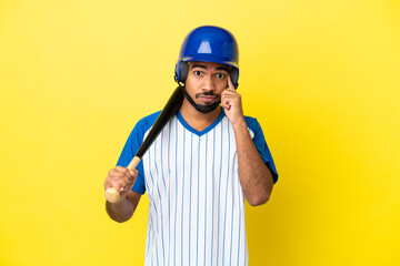 Young Colombian latin man playing baseball isolated on yellow background thinking an idea