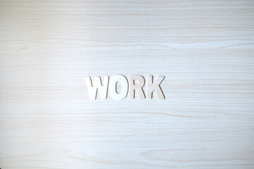 The word WORK, Wooden letters on wooden table.