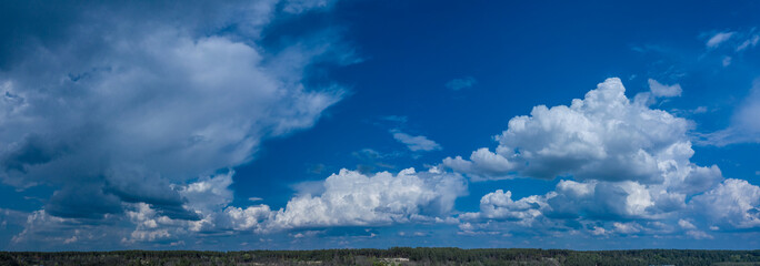Deep blue sky and white different types of clouds in it. Beautiful nature background.