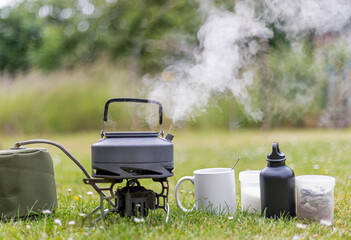 Kettle boiling on a camping stove to make a cup of tea whist camping
