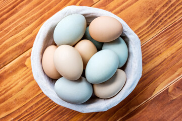 Fresh Chicken and duck eggs collect from farm products natural on a wooden table. Healthy eating concept - Top View