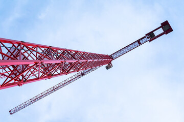 Single construction crane close-up at BudaPart construction site in twilight near to MOL Campus building, Kopaszi-gát.