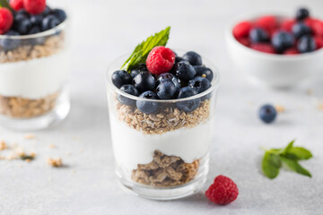 Fototapeta na wymiar Granola with yogurt, blueberries and raspberries. Healthy breakfast. Menu, recipe.