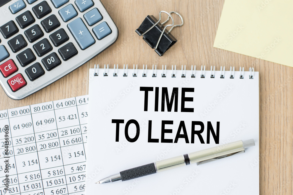 Poster text time to learn on a notepad, pen and office tools on an active background. business concept