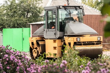 Laying of asphalt. Road roller tamping asphalt