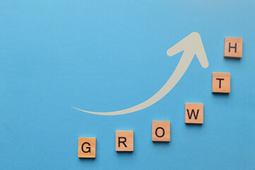Arrow up and wooden blocks with text GROWTH.