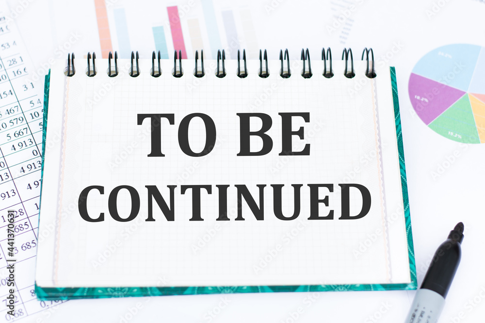 Poster notebook with text to be continued on office desk