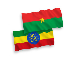 National vector fabric wave flags of Burkina Faso and Ethiopia isolated on white background. 1 to 2 proportion.