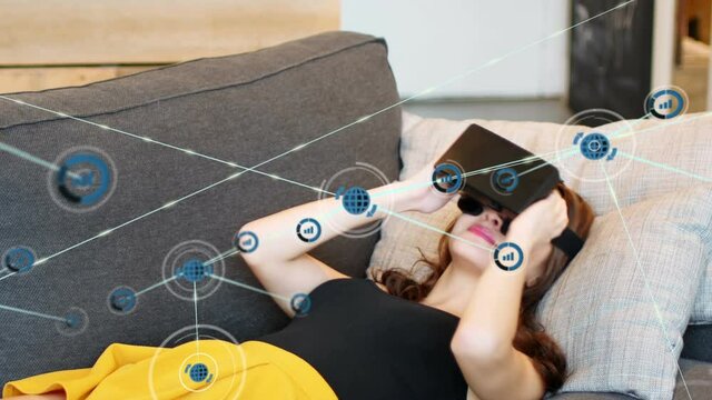 Animation of network of connections with icons over woman wearing vr headset