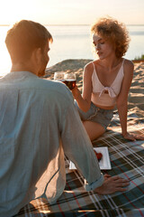 Loving young caucasian couple drinking red wine