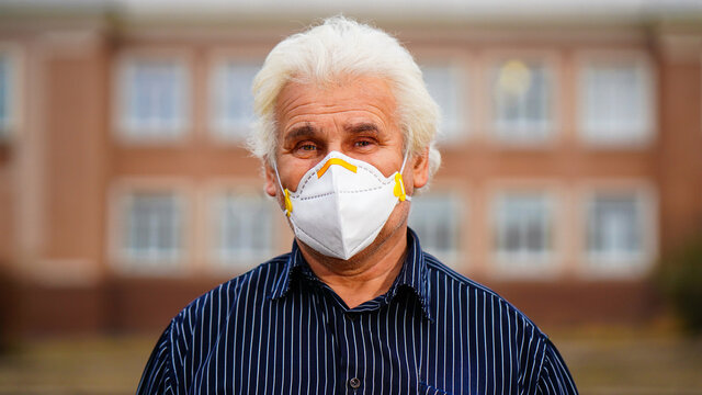Old Man with face mask against virus, grandfather on green background. Brazilian man. - Powered by Adobe