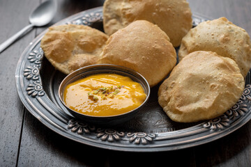 Aam Ras Puri or Alphonso Mango pulp with fried Poori