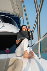 Asian young businesswoman with laptop at the yacht in summer