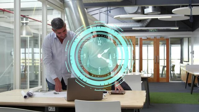 Animation of clock moving fast over business colleagues using laptop in office