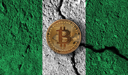 Bitcoin crypto currency coin with cracked Nigeria flag. Crypto restrictions