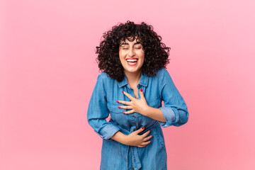 pretty arab woman laughing out loud at some hilarious joke