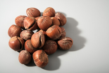 dessert hazelnuts boiled in vanilla syrup, with cracked nutshell, gray background with copy space